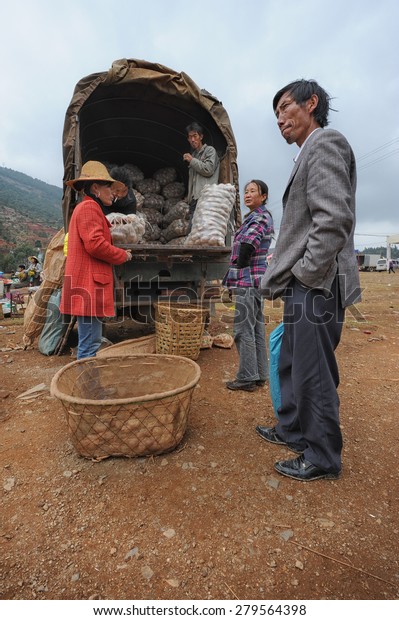 DALI - APRIL 19: Chinese\
farmers sell their goods on the local market on April 19, 2014 in\
Dali, China. Many Chinese farmers have a income of just 1800 US\
dollars a year. 