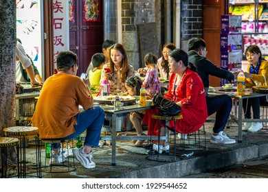 Dali China , 6 October 2020 : Chinese family having dinner at an outdoor restaurant in Dali Yunnan China