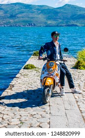 Dali / China - Oct 2018: The tourist with scooter near Erhai lake in Dali, Yunnan province.