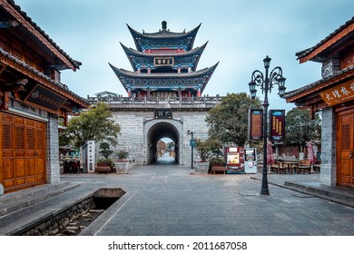 Dali, Yunnan, China - January, 2021: A street of the ancient town of Dali with a pagoda tower, steet lamps andtraditional Chinese two-storeyed buildings
