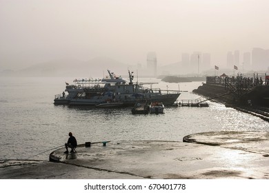 Dalian, China - August 14, 2011: View On Sea Coast And Foggy City From Xinghai Park In The Evening, Soft Light, Monochrome