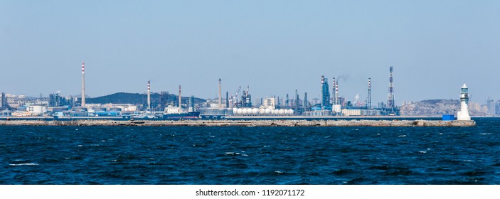 Dalian, Liaoning, China - March 25 2012: Dalian Harbour with Dalian PetroChina Refinery Plant