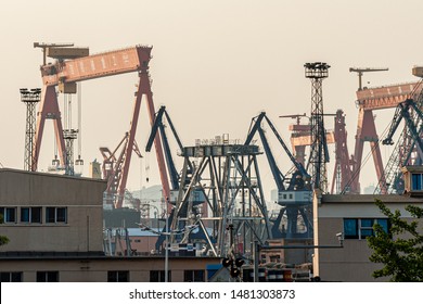 Dalian, Liaoning, China - March 25 2012: Crane booms in Dalian Shipyard