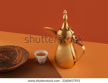 dallah is a metal pot with a long spout designed specifically for making Arabic coffee, Saudi coffee wood background, arabic coffee and dates.