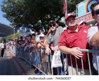 DALLAS, TEXAS—OCTOBER 2017: Crowds gather by the roadside to watch the marching bands from Oklahoma and Austin,Texas march to the Cotton Bowl Stadium during the Texas Fair game.