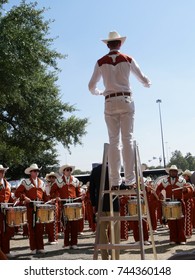 DALLAS, TEXAS—OCTOBER 2017: University Of Texas University Longhorn Marching Band Warm Up Exercises Outdoors Under The Supervision Of Their Drum Major Before The Cotton Bowl Game Started. 