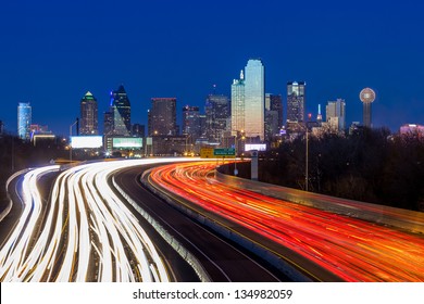Dallas downtown skyline at night, Texas with interstate road and traffic