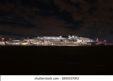 Dallas Fort Worth Airport, Texas, November 8 2020: nighttime DFW airport international terminal with american airlines aircraft.