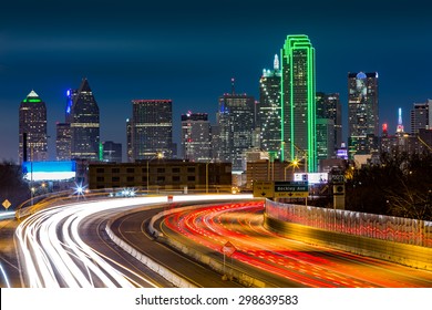 Dallas skyline by night The rush hour traffic leaves light trails on I-30 (Tom Landry) freeway.