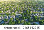 Dallas suburbs and urban sprawl with row of single-family houses fenced backyard, grassy lawn in subdivision outside DFW metro complex, upscale suburban homes with swimming pool, aerial view. USA