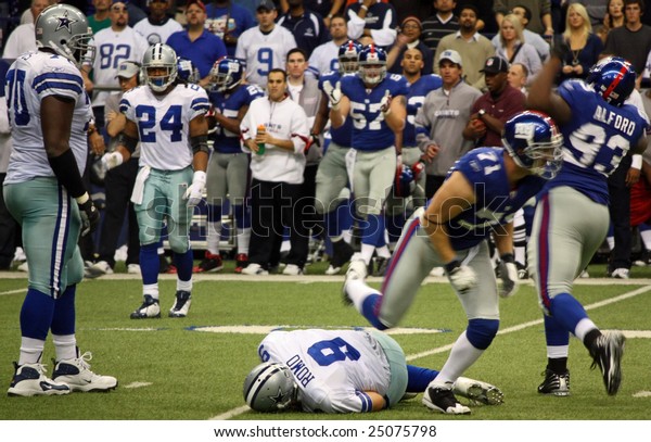 DALLAS, TEXAS - DEC\
14: Dallas Cowboys Quarterback Tony Romo is sacked by the NY Giants\
defense during a game at Texas Stadium  in Dallas, Texas, on\
Sunday, December 14,\
2008.