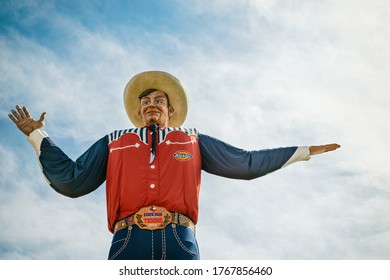 Dallas, Texas - October 17, 2019: Closeup of the Big Tex statue. The figure icon greets and waves his hands to welcome visitors at the State Fair of Texas fairgrounds.