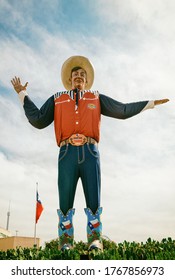 Dallas, Texas - October 17, 2019: Big Tex statue standing tall at Fair Park. The icon greets and waves his hands to welcome visitors at the Texas State Fair fairgrounds. 