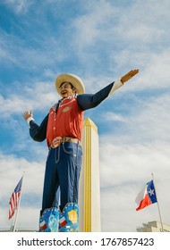 Dallas, Texas - October 17, 2019: Big Tex statue standing tall at Fair Park. The icon greets and waves his hands to welcome visitors at the State Fair of Texas fairgrounds. 