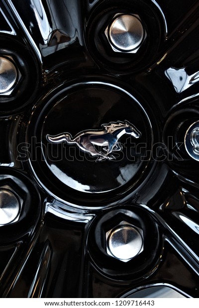 Dallas Texas - September 21,\
2018 The Ford Mustang logo on a black rim inside the dealer\
showroom 