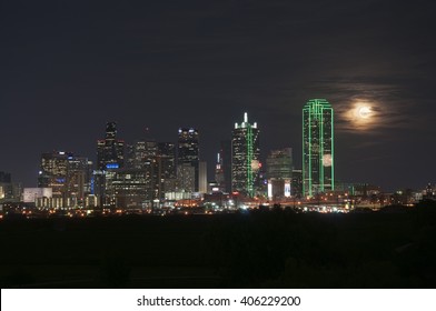 The Dallas, Texas Skyline At Night With A Full Moon From The Trinity River Greenbelt Park.