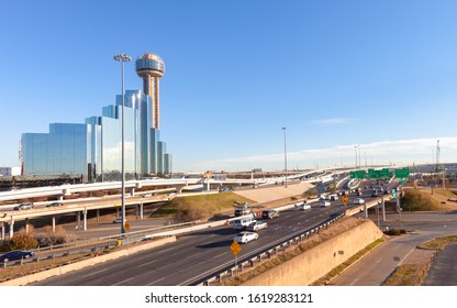 Dallas, Texas skyline with view of traffic on Interstate 30, with direction signs towards Waco, Texarkana and Ft. Worth on a sunny summer day