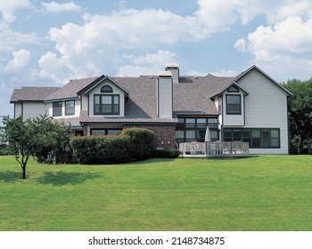 Dallas, Texas, United States - July 15, 2003: Summer View Of Green Lawn And A Town House With Windows Against Cumulus In The Sky
