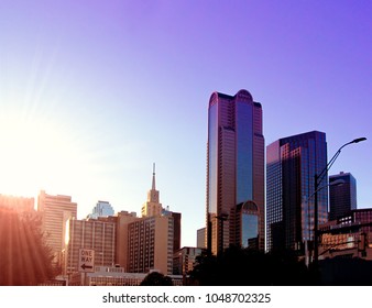 DALLAS, TEXAS, USA - OCTOBER 23, 2017. Street Cityscape At Sunset In Downtown Of Dallas.
City Skyline With Modern Buildings And Skyscrapers In City Center District Against A Bright Sun. 