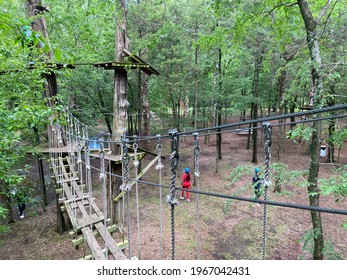 Dallas TX USA - May 2 2021: Climbers And Novices Enjoy An Afternoon Of Ropes And Zip Lines At Trinity Forest Adventure Park