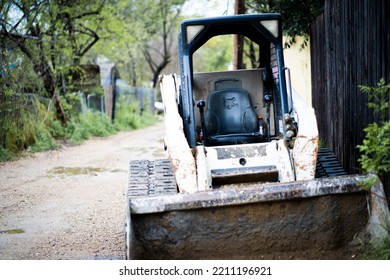 DALLAS, UNITED STATES - Mar 18, 2020: An Abandoned Bobcat Tractor In An Alley In Dallas, Texas