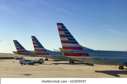  DALLAS, USA - MAR 30, 2017: DFW international airport runway with American Airlines  aircrafts getting ready for take off. 
