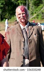 DALTON, GA - SEPTEMBER 14:  A Bloody Elderly Male Zombie Gets Ready To Take The Field To Menace Runners In The Run For Your Lives 5K Event, On September 14, 2013 In Dalton, GA.   