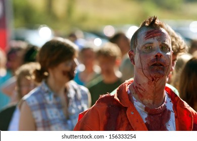 DALTON, GA - SEPTEMBER 14:  A Bloody Male Zombie Waits In Line To Be Splashed With More Fake Blood So He Can Terrorize Runners In The Run For Your Lives 5K Event On September 14, 2013 In Dalton, GA.  