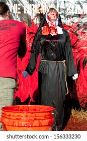  DALTON, GA - SEPTEMBER 14:  A Woman In A Nun's Habit Costume Gets Fake Blood Thrown On Her So She Can Menace Runners In The Run For Your Lives 5K Zombie Event, On September 14, 2013 In Dalton, GA.  