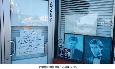 Daly City, CA, USA 
May 19, 2022
A Sign Making Reference To Covid Causing To Change Of Hours On The Door Of A Barber Shop.