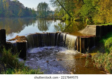 A dam reservoir on the river - damming dam.A small dam -  water tame over the river  - Shutterstock ID 2217849575