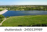 Dam sites at upper Brushy Creek Lake Park next master-planned community in Brookside neighborhood near Austin, 90-acre lush greenery area, nature trails, people enjoy picnic activities, aerial. USA