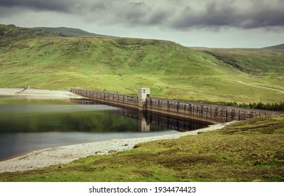 The Dam Wall Of Loch Daimh Reservoir Water Supply In The Scottish Highlands, UK Landscapes.