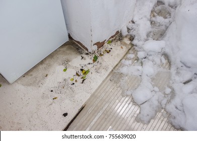 Damage To Interior Of House After Snow Destroyed Roofing And Fell Into The Room And Exposed It To The Outside Elements. Detail Of Kitchen Floor, Snow And Debris. 