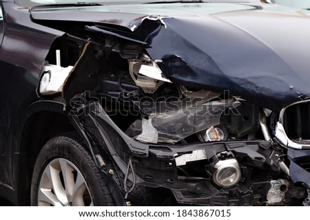 Damage resulting from a jeep car accident. The front part and headlight of the car are broken.