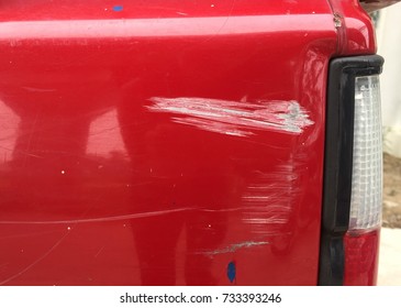 Damage Scratch On Back Of Red Car