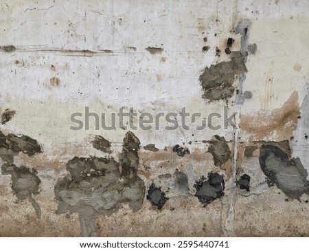 Damage to the white wall. Cement plaster patches on the wall with holes. Seal the damaged wall using cement