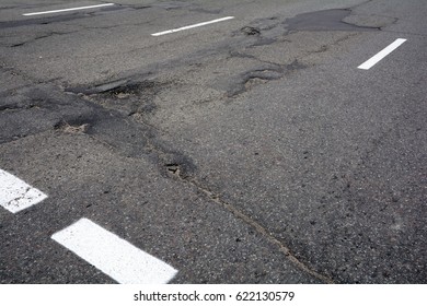 Damaged Asphalt Road With Poor Quality Of Repair Work. 