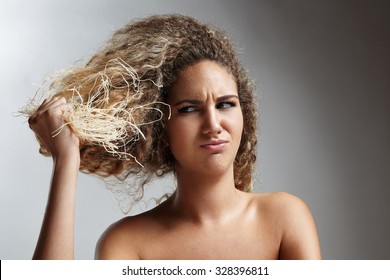 Damaged Blond Hair Concept. Woman Hold Dry Hair