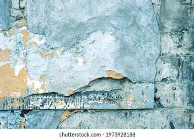Damaged blue wall texture background. Creative backdrop. Old, closed factory building wall fragment. Weathered and cracked bricks with concrete and peeled off blue paint. Close up, copy space