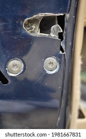 Damaged Bolts On A Car Door Latch