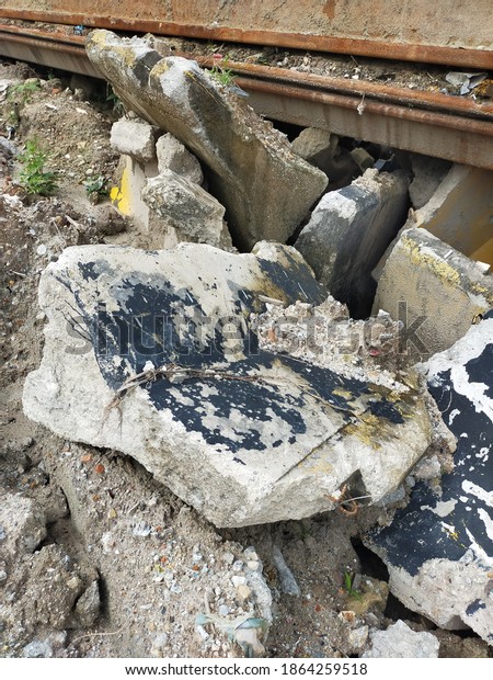 Damaged and broken\
concrete barriers are collected somewhere in the construction area\
before disposal.