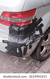 A Damaged Car Bumper (Fender) Fixed With Duct Tape