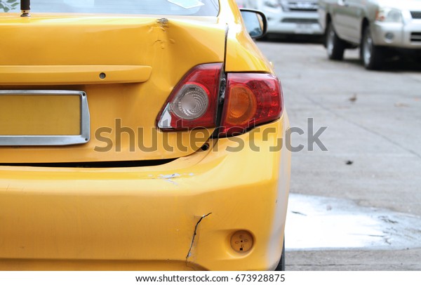 Damaged car, dented on an old\
car