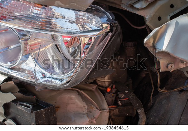 Damaged car detail on crushed car, wrecked vehicle.
Crushed metal and plastic after a traffic accident in Bucharest,
Romania, 2021