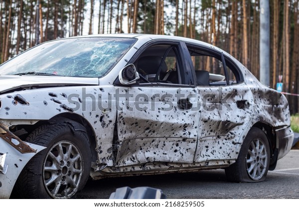 Damaged car during the war in Ukraine. The car of\
civilians was damaged during the evacuation. Shrapnel and bullet\
holes in the car body. War of Russia against Ukraine. Ukraine,\
Irpen - May 12, 2022