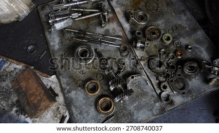 Damaged Car Engine Part With Used Oil Stains on the Floor