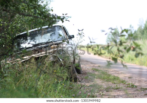 damaged car on the side of\
the road