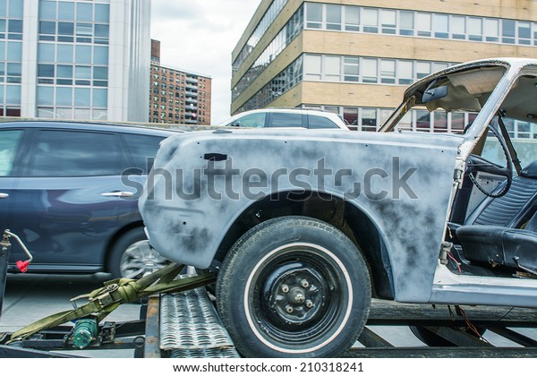 Damaged car\
on a tow truck after a street\
accident.