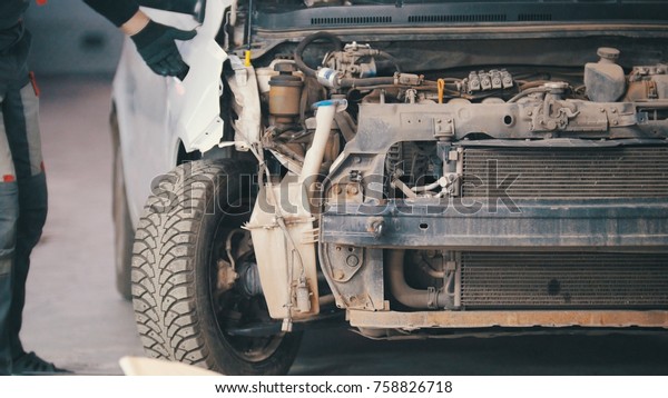 Damaged car preparing for professional diagnostics in\
auto service, close up